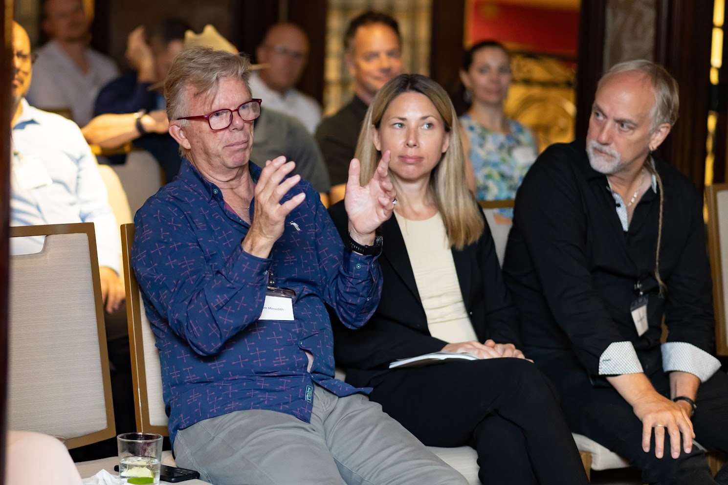 Approximately 20 investors seated in a luxury living room, listening to a founder fireside conversation during an Astronomic Investor Dinner.